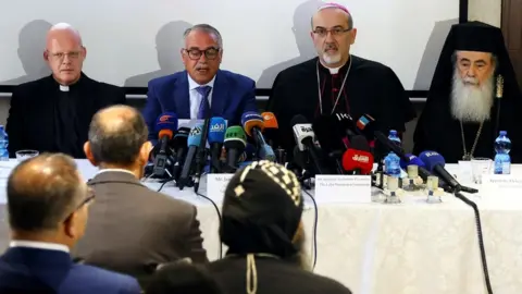 Reuters Monsignor Tomasz Grysa (L), St Joseph Hospital director Jamil Moussa (2nd L), Latin Patriarch Archbishop Pierbattista Pizzaballa (2nd R), and Greek Orthodox Patriarch Theophilos III (R) speak at a press conference in Jerusalem on 16 May 2022