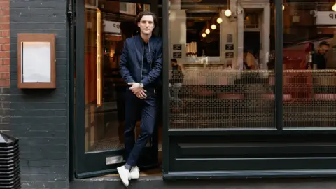 Tom Griffiths Rik Campbell outside his restaurant