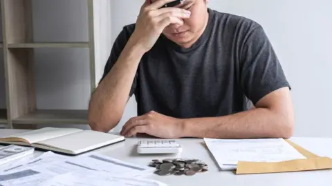 Getty Images Man stressed about money