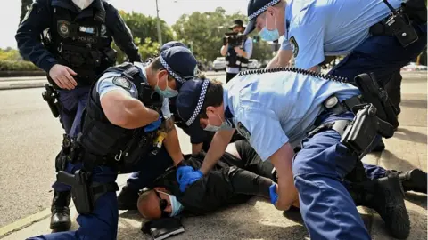 EPA A protester is arrested by police in Sydney, Australia, 21 August 2021