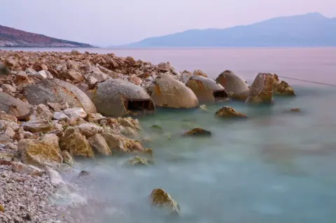 Robert Hackman Bunkers in Albania next to a lake