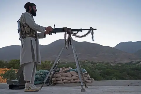 AFP This photo taken on July 8, 2022 shows a Taliban fighter keeping a watch at an outpost in Tawakh Village of Anaba district, Panjshir Province.