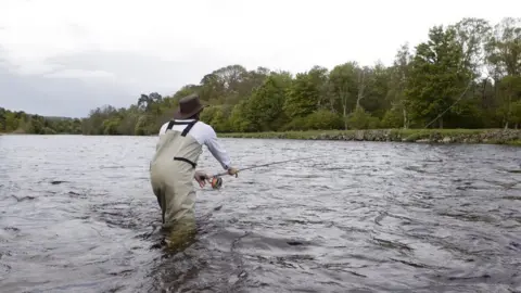 Getty Images man fishing in river