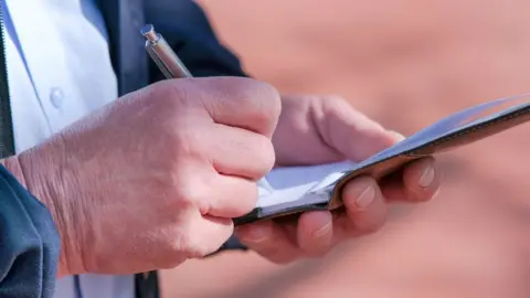 Getty Images Close up of a person writing a fine