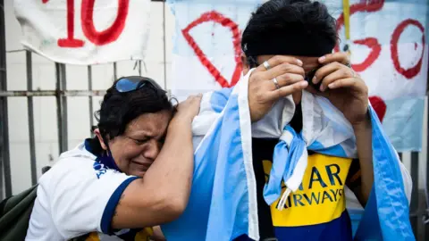 Getty Images Fans cry for Diego Maradona after the news of his in Buenos Aires