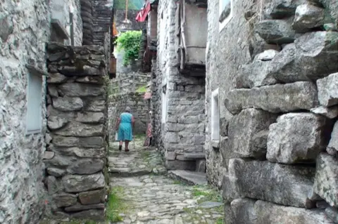 Old lady in a Corippo street