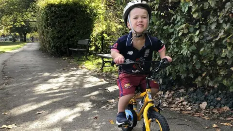 Jenn Short Sam on his bike