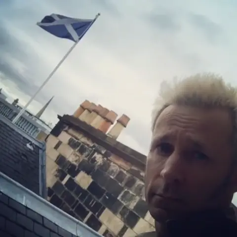 Mike Dirnt Mike Dirnt next to a Saltire