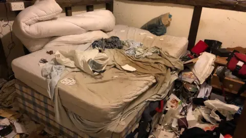 BBC A bedroom full of clutter