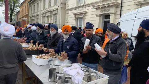 SANTOSH KAUR Outside Soho Road Gurdwara being served food