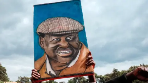 AFP A portrait of Raila Odinga being held aloft at a campaign rally - Kenya 2022