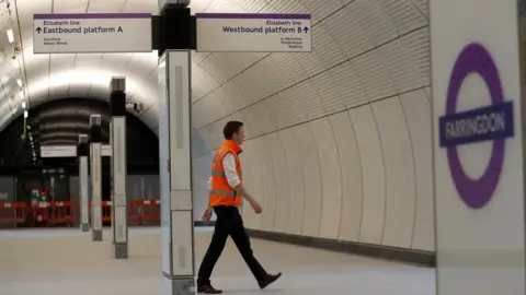 REUTERS/Peter Nicholls A Crossrail employee walks in the new Farringdon underground station of the Elizabeth line