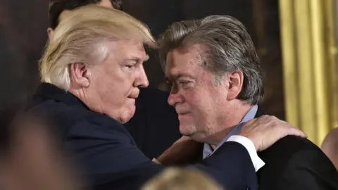 AFP US President Donald Trump (L) congratulates Senior Counselor to the President Stephen Bannon during the swearing-in of senior staff in the East Room of the White House on 22 January, 2017 in Washington DC.