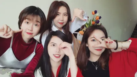 Family photo of Sophie and her three cousins dressed in red