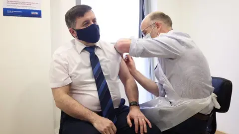 Department of Health Robin Swann receiving vaccine