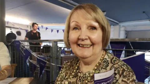 An older woman in a cafe