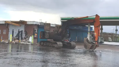 PSNI A digger was used to steal an ATM machine from a filling station wall