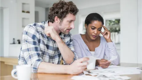 Getty Images Couple looking at bill