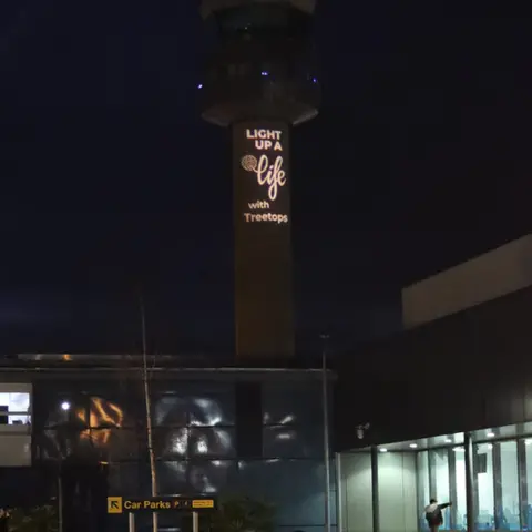 Treetops  Air traffic control tower displaying hospice Christmas appeal message