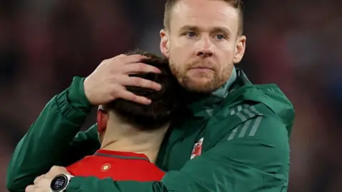 Chris Gunter hugs Dan James