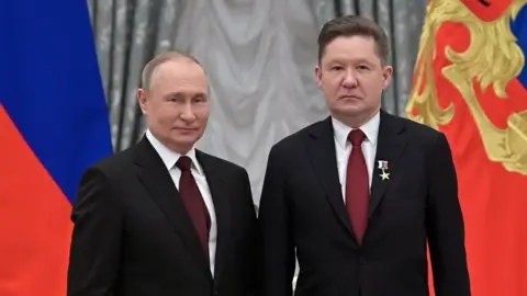 Kremlin/EPA Alexey Miller (R) with Putin at the Kremlin on 2 February