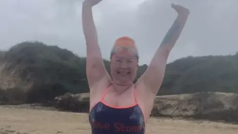 Nicola Napier Gill Castle standing on a beach in France having completed her Channel Swim