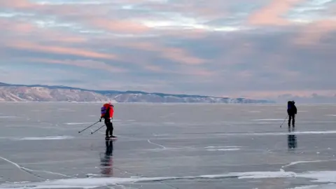 Oleg Boldyrev Two men skating on the frozen lake