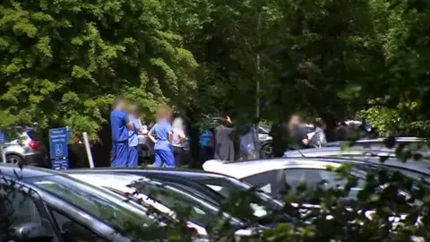 BBC Health workers queuing for coronavirus testing