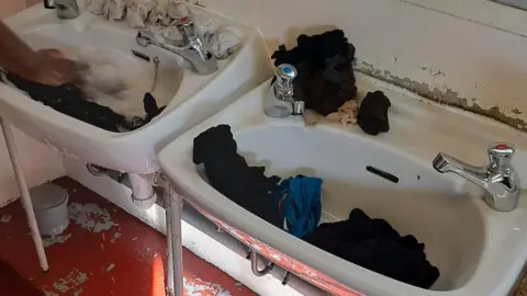 Clothes being washed in a sink