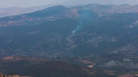 Smoke rises in Kfar Shouba, as seen from the village of Khiam, southern Lebanon, near the border with Israel (6 July 2023)