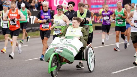 PA Media Sandra and David Kerr with their son Aaron