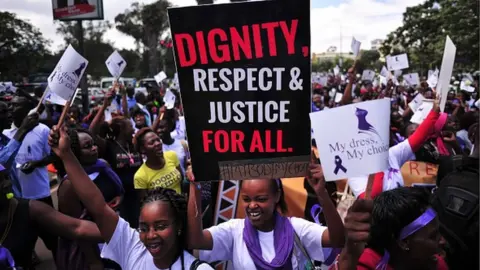 AFP Women hold up placards and shout slogans during a rally against violence to women, on November 17, 2014 in Nairobi.