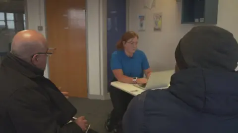 Mohammed (right) during his consultation with Robyn Dunbar-Smith of the Scottish Refugee Council and an interpreter (left)