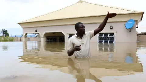 Getty Images A man in a town near Lokoja, a heavily flooded area