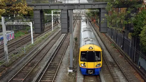 BBC London Overground train travelling on tracks