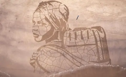 Google A giant sand portrait by WaterAid and artists Sand In Your Eye of Ansha, a 12-year-old from Frat in Ethiopia adorns Whitby Beach on March 15, 2021 in Whitby, England. Ahead of World Water Day on 22 March WaterAid created the portrait in the sand on Whitby Beach of a child carrying water next to the rising tide, to highlight the impact climate change is having on people’s access to water. The 60-metre wide artwork depicts Ansha from Frat in Ethiopia, who spends hours each day walking to and collecting dirty water from a river. After only an hour Ansha’s image was washed away by the rising tide – highlighting how excess rainfall and rising sea levels can lead to flooding, contaminating water and endangering lives.