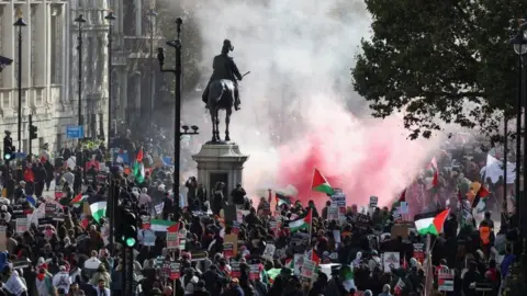 Reuters Demonstrators protest in solidarity with Palestinians in central London, flares have been set off and flags are being waves