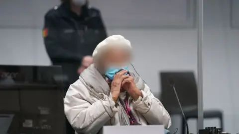 Getty Images Defendant Irmgard F, a former secretary for the SS commander of the Stutthof concentration camp, waits for the continuation of her trial at court in Itzehoe, northern Germany, on December 6, 2022