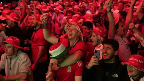 Getty Images England and Wales fans watch the match together in London