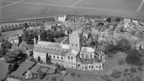 Historic England Archive/Harold Wingham Collection Black and white aerial photograph of a cathedral