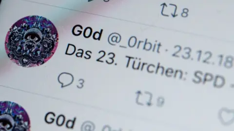 EPA A photograph of a screen shows tweets by twitter user @_0rbit in German, mentioning the SPD political party