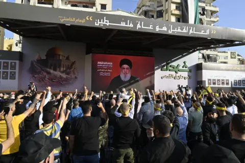 WAEL HAMZEH/EPA-EFE/REX/Shutterstock Hassan Nasrallah addresses supporters on a TV screen