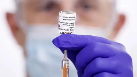 PA Media Syringe being prepared with Oxford/AstraZeneca coronavirus vaccine at the Elland Road vaccination centre