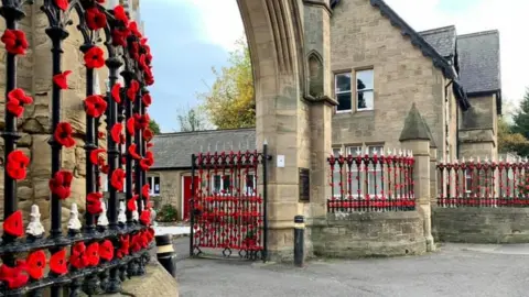 Mark William Young Gates to Hebburn cemetery covered in knitted poppies