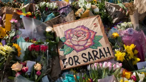 Getty Images Flowers laid at vigil