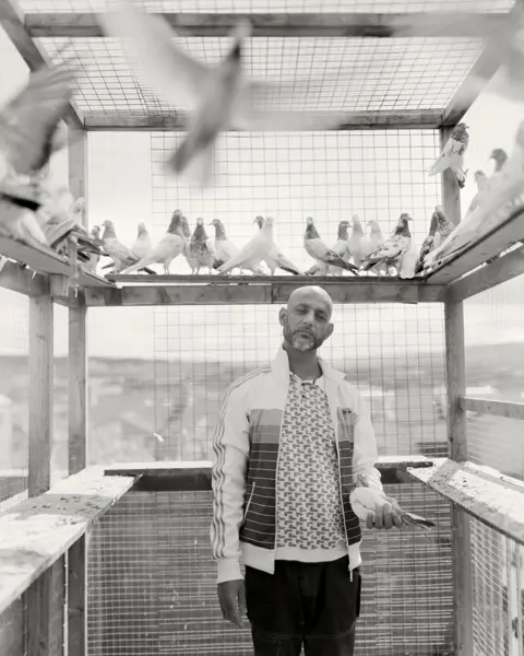 Craig Easton Black and white portrait of a man surrounded by birds