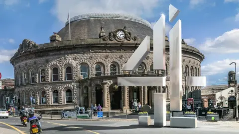 Peter Chan/Alamy Stock Photo Channel 4 logo and Leeds Corn Exchange