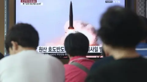 EPA People in Seoul, South Korea, watch breaking news of North Korea's missile launch in July 2019