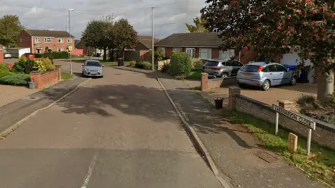 Google A modern cul-de-sac with trees and parked cars