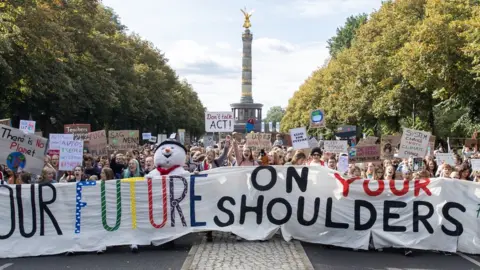 EPA Protesters with a banner "Our future on your shoulders" attend a demonstration at the Victory Column